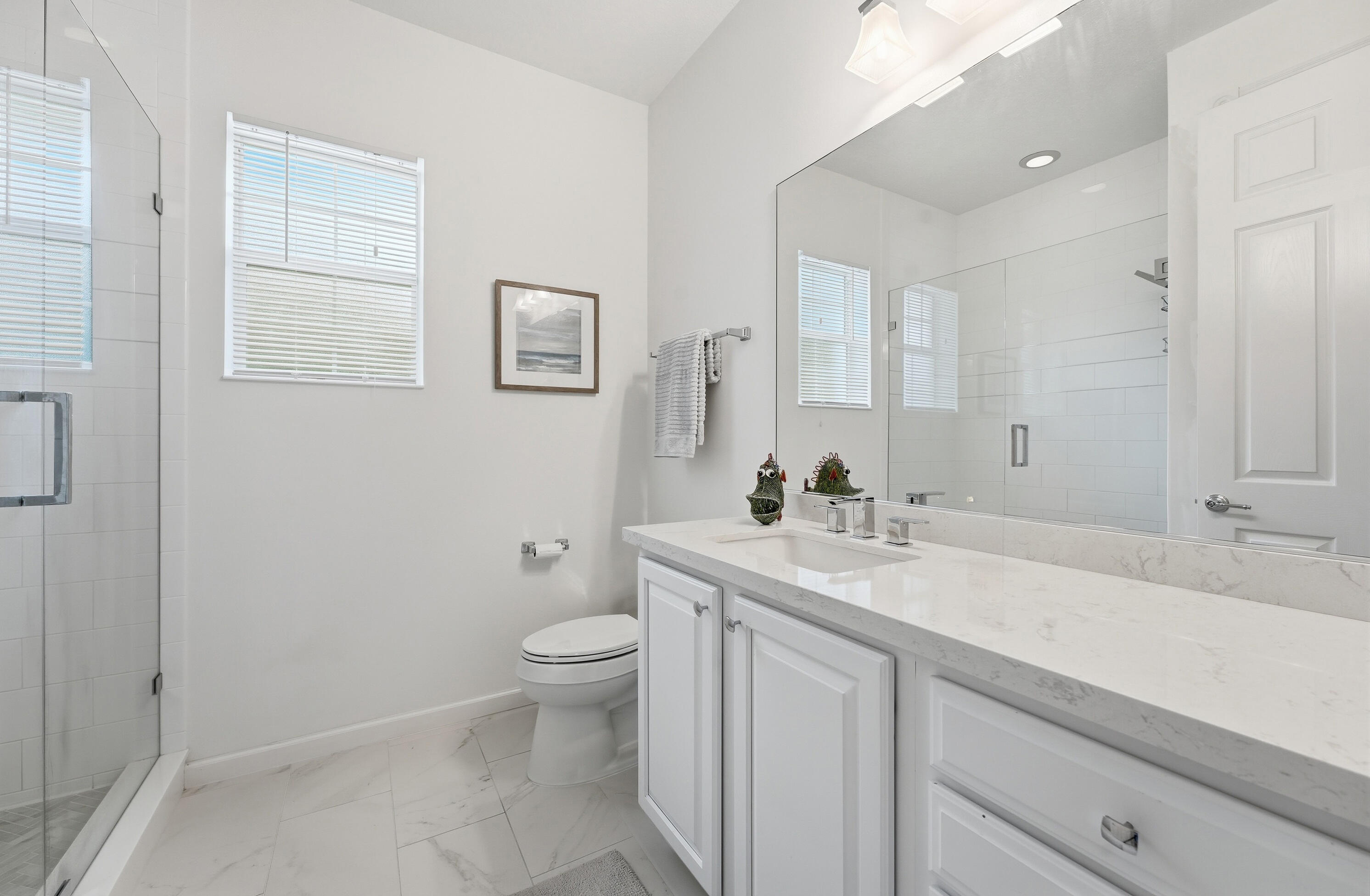 3443 South Caroline Street Jupiter, FL 33458 - Photo 32 of 60 a bathroom with a sink toilet and mirror