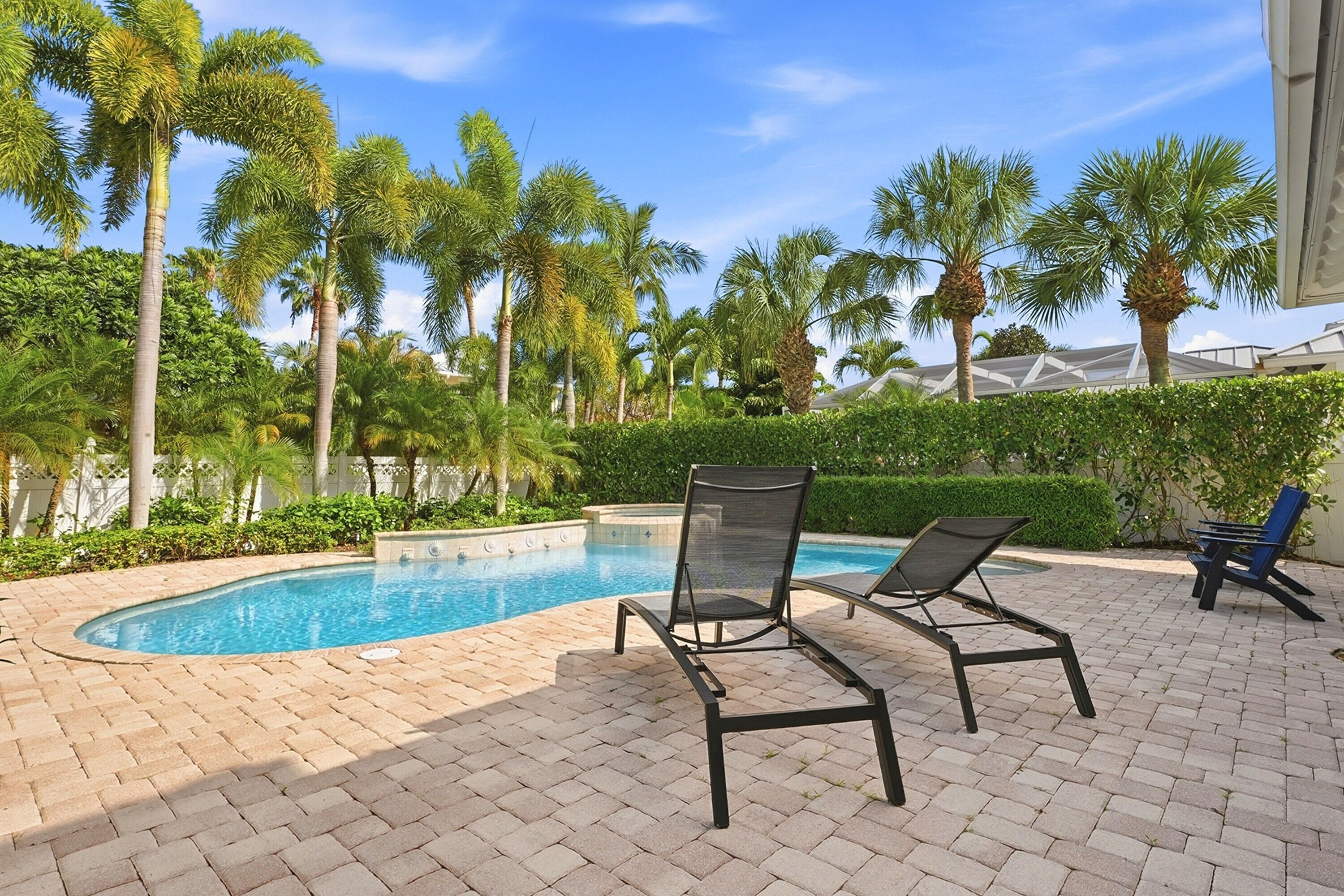 3443 South Caroline Street Jupiter, FL 33458 - Photo 39 of 60 a view of a swimming pool with a lounge chair