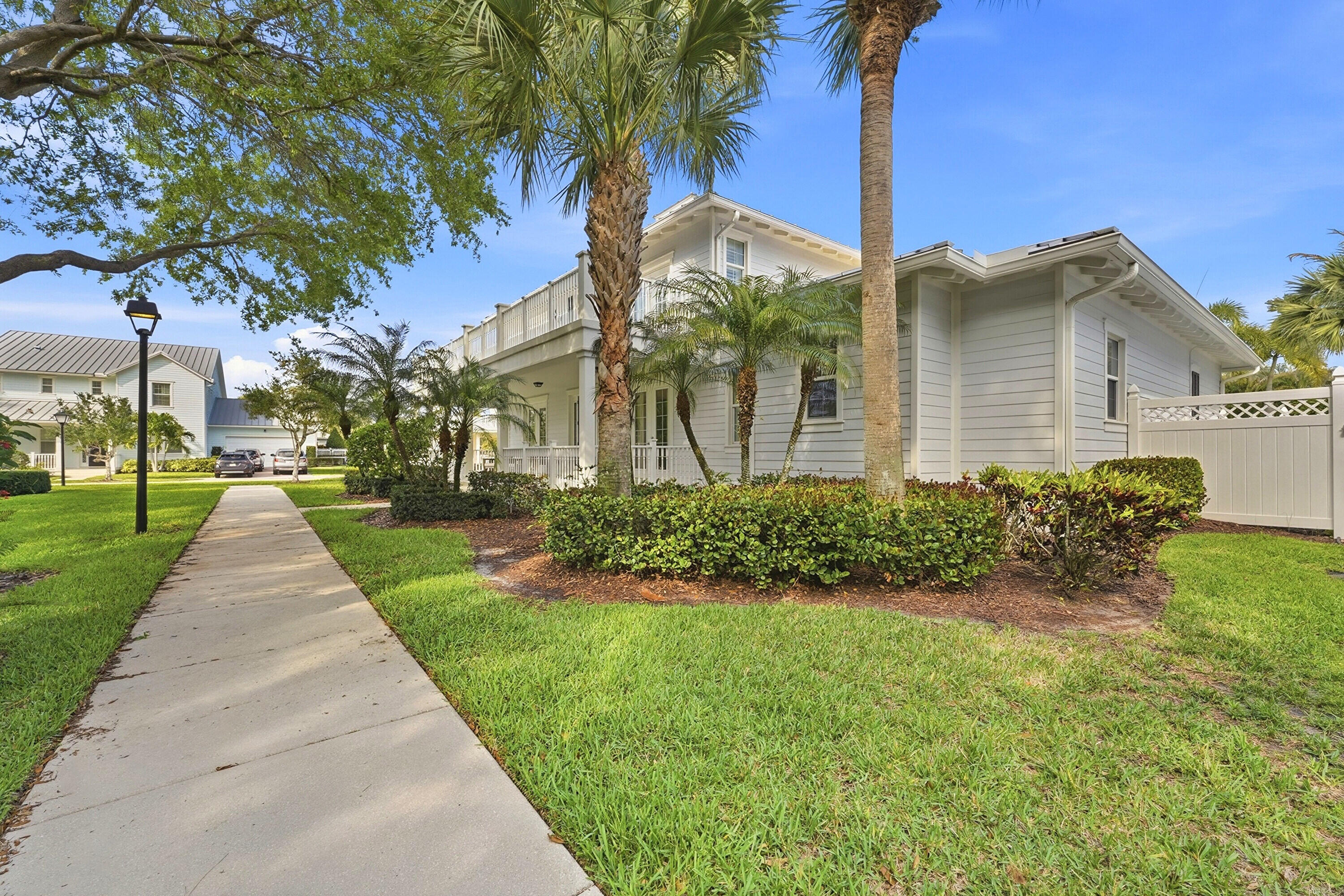 3443 South Caroline Street Jupiter, FL 33458 - Photo 43 of 60 a front view of a house with a yard and potted plants
