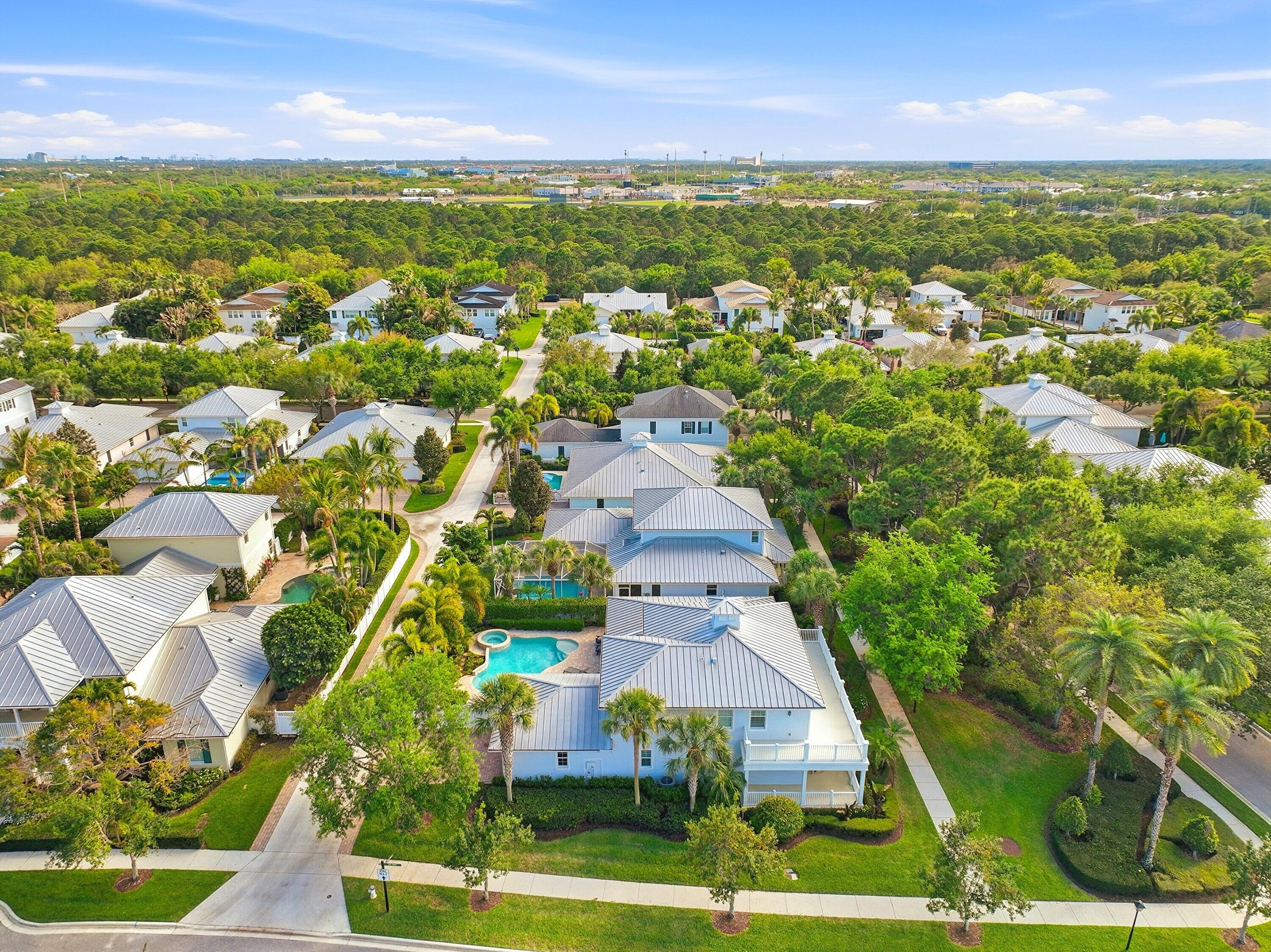 3443 South Caroline Street Jupiter, FL 33458 - Photo 54 of 60 an aerial view of residential houses with outdoor space and trees