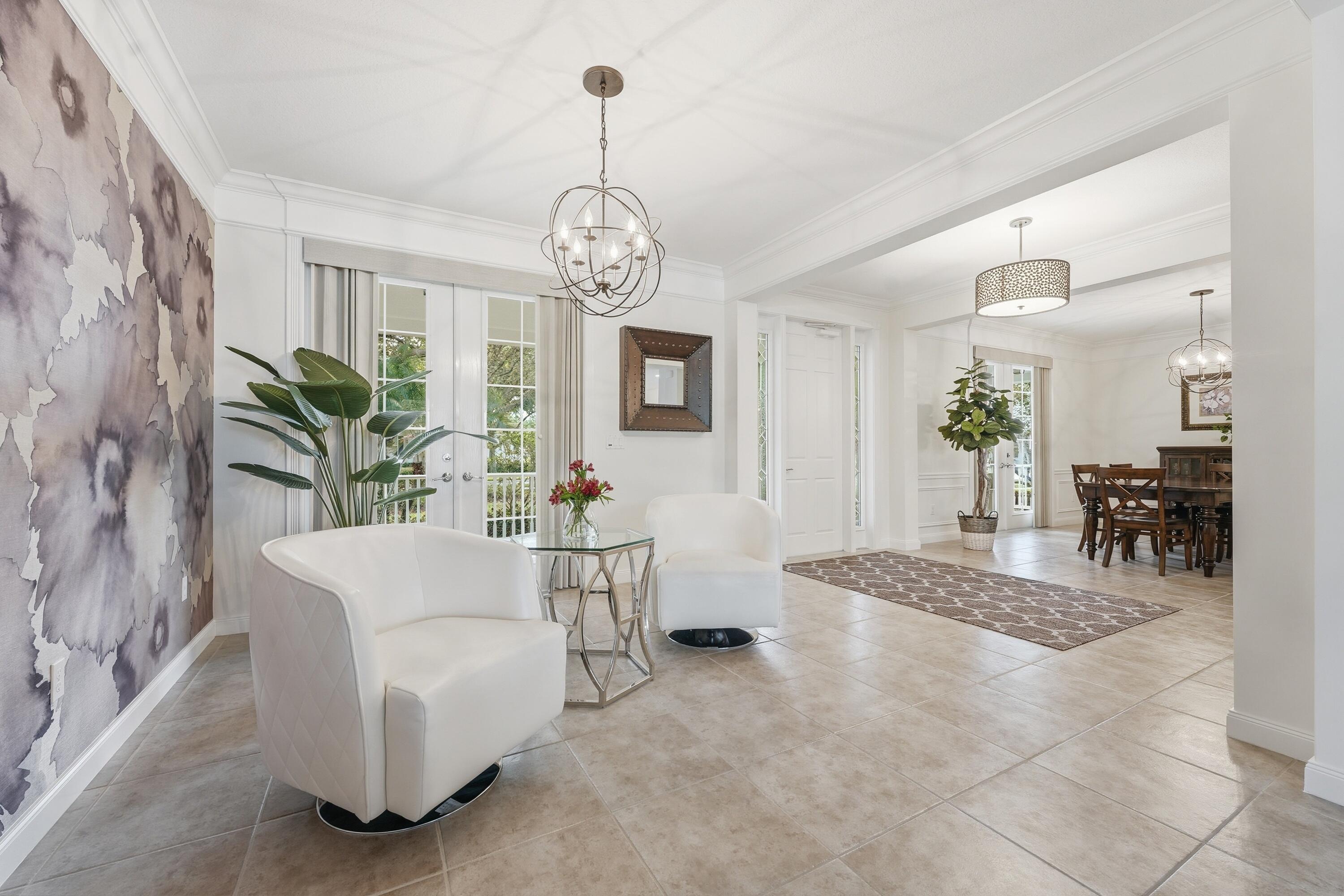 3443 South Caroline Street Jupiter, FL 33458 - Photo 6 of 60 a view of a livingroom with furniture a chandelier and wooden floor