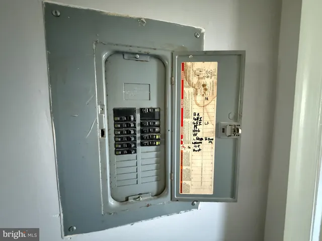 a kitchen with granite countertop a stove a sink and a refrigerator