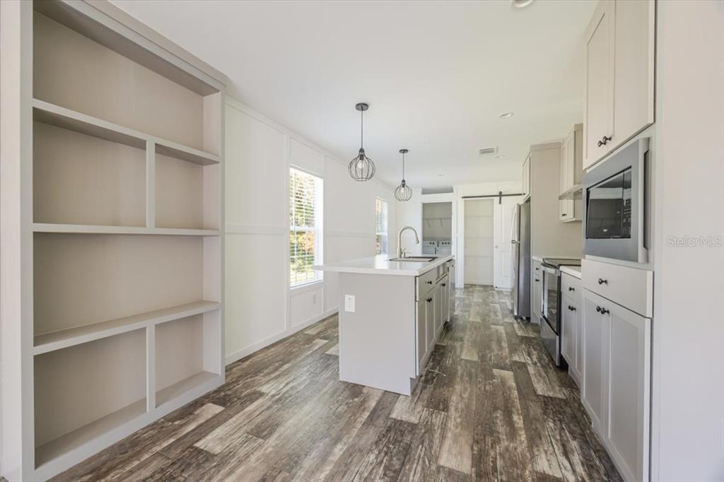 326 Smith Road Polk City, FL 33868 - Photo 13 of 26 a kitchen with cabinets and wooden floor