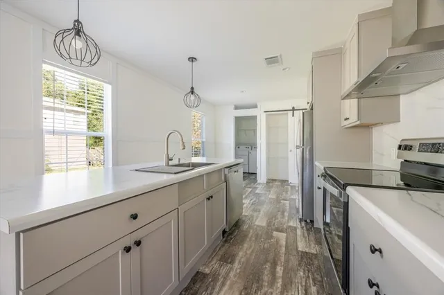 a kitchen with sink cabinets and window