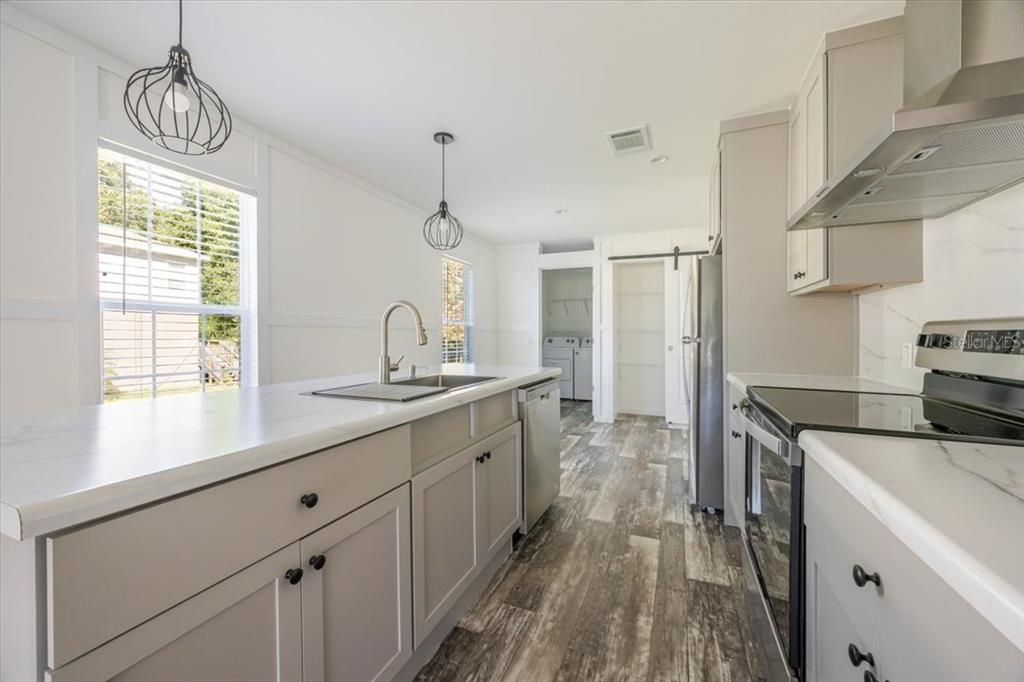 326 Smith Road Polk City, FL 33868 - Photo 15 of 26 a kitchen with sink cabinets and window