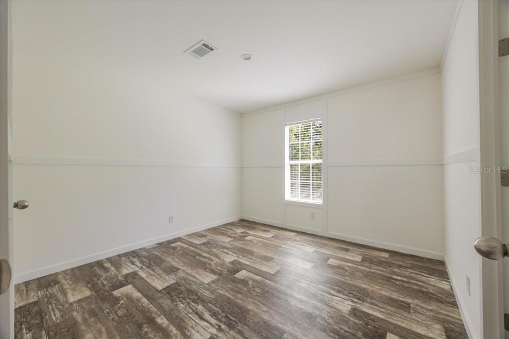 326 Smith Road Polk City, FL 33868 - Photo 21 of 26 a view of empty room with wooden floor and fan