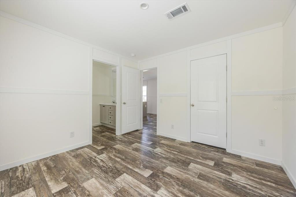 326 Smith Road Polk City, FL 33868 - Photo 22 of 26 a view of a livingroom with wooden floor and a bathroom