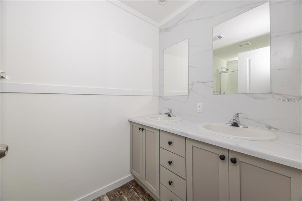 326 Smith Road Polk City, FL 33868 - Photo 23 of 26 a bathroom with a sink and a mirror