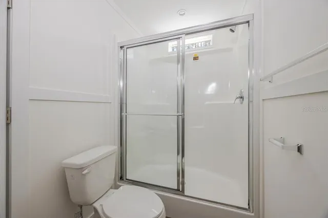 a bathroom with a shower a toilet and a sink