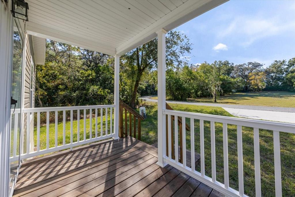 326 Smith Road Polk City, FL 33868 - Photo 5 of 26 a view of a wooden deck with a yard