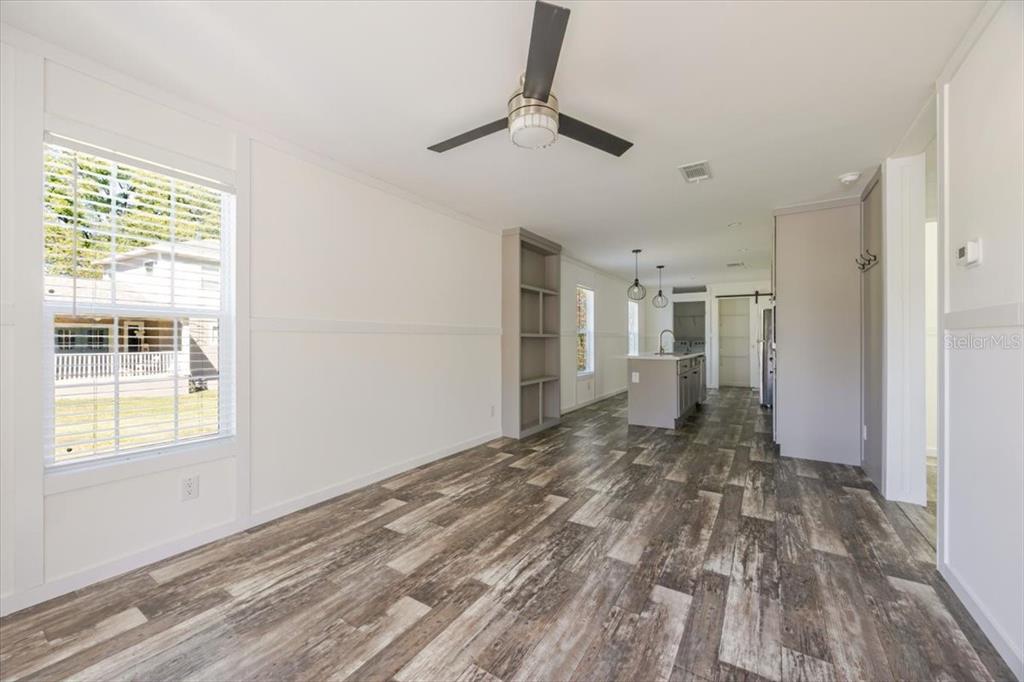 326 Smith Road Polk City, FL 33868 - Photo 6 of 26 a view of empty room with wooden floor and fan