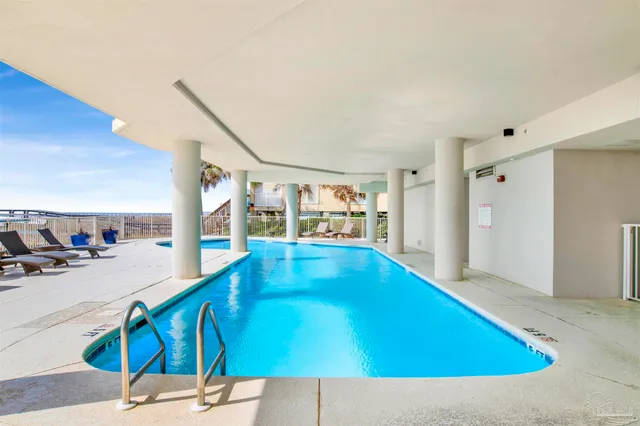a view of a house with pool and sitting area
