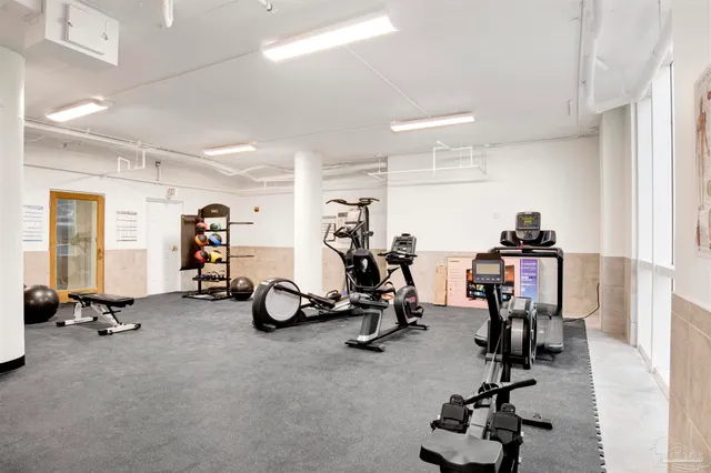 a view of a livingroom with workspace and a window