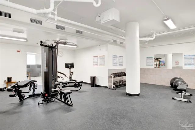 a room with furniture pool table and wooden floor