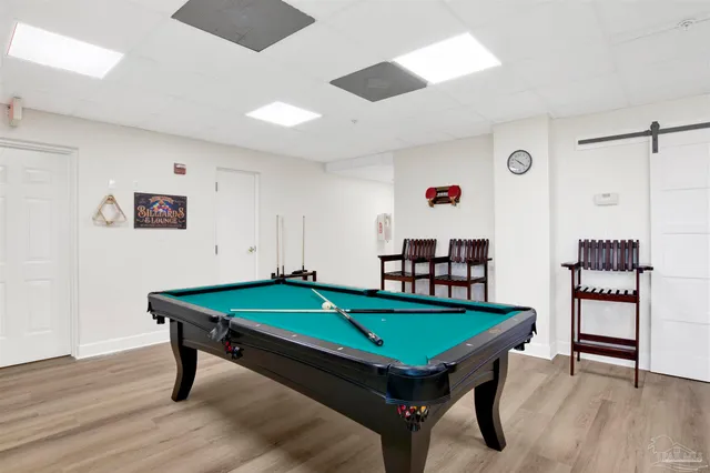 a room with pool table and windows