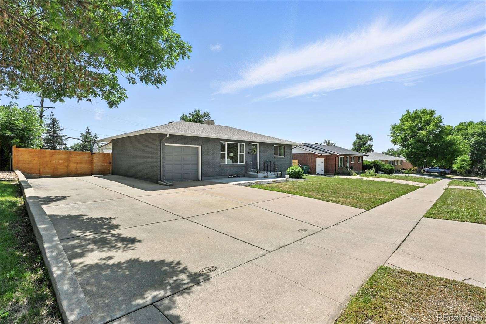 2714 South Raleigh Street Denver, CO 80236 - Photo 2 of 34 a front view of a house with a yard