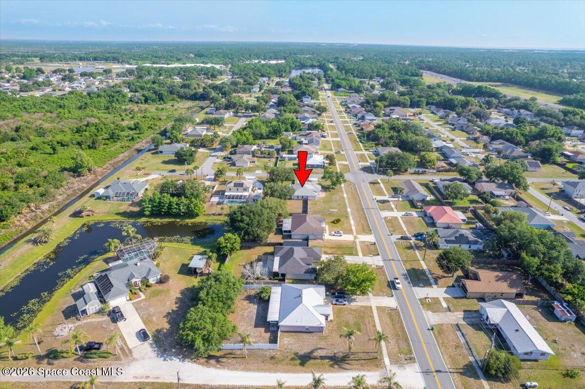 5975 Aruin Street Cocoa, FL 32927 - Photo 64 of 70 an aerial view of residential houses with outdoor space and trees