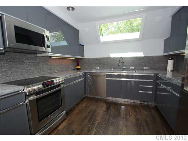 8009 Rising Meadow Road Charlotte, NC 28277 - Photo 8 of 16 a kitchen with a stove and a microwave