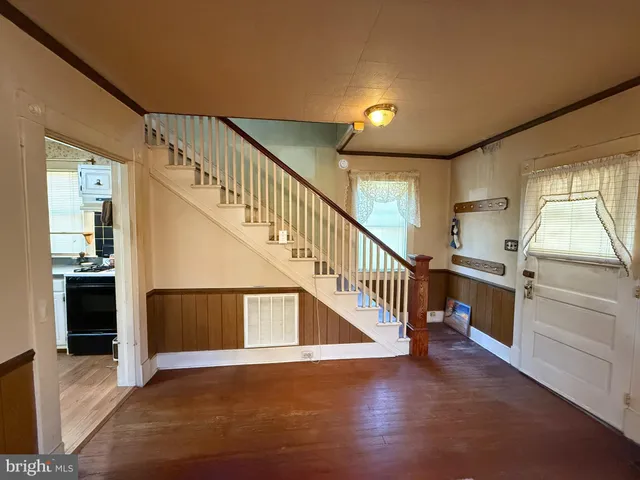a view of entryway and hall with wooden floor