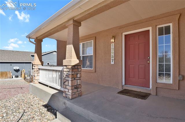 12237 Rio Secco Road Peyton, CO 80831 - Photo 4 of 45 Doorway to property with covered porch