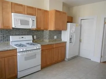a kitchen with a stove sink and cabinets