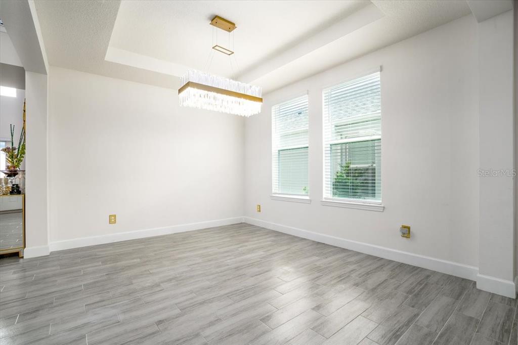 1296 Waterview Ridge Circle Apopka, FL 32703 - Photo 15 of 60 an empty room with wooden floor and windows