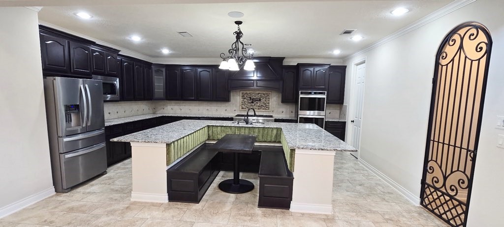127 Bridgewater Onalaska, TX 77360 - Photo 8 of 34 a kitchen with stainless steel appliances granite countertop a sink refrigerator and cabinets