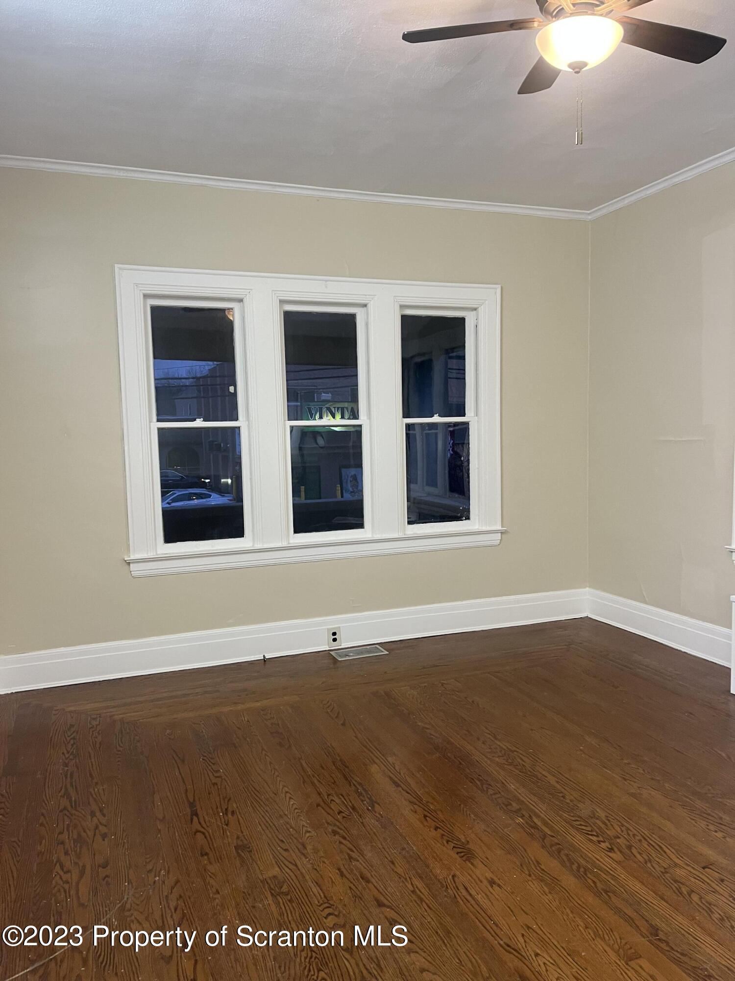 85 Main Street, Unit 1 Dickson City, PA 18447 - Photo 6 of 8 a view of an empty room with wooden floor and windows