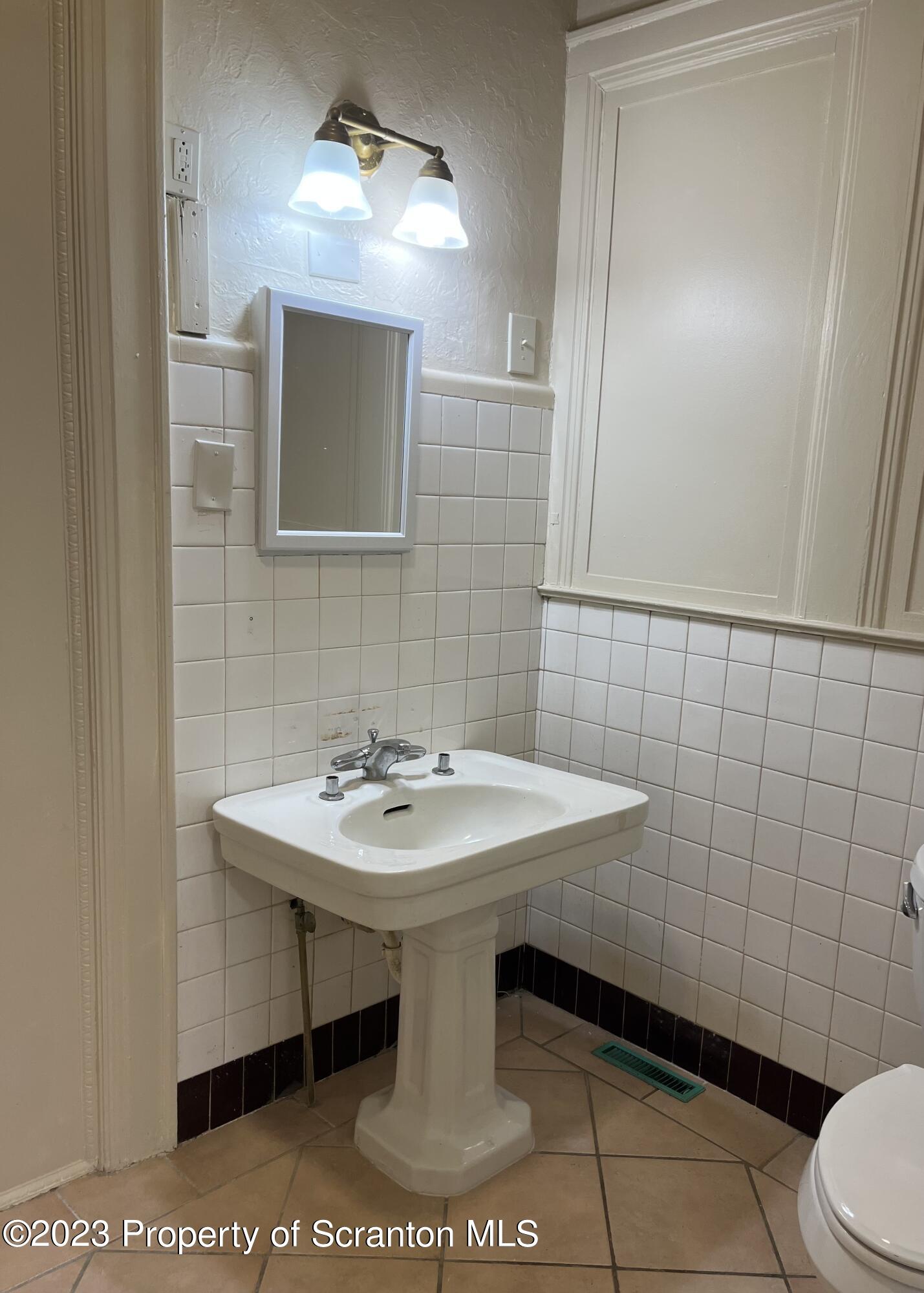 85 Main Street, Unit 1 Dickson City, PA 18447 - Photo 8 of 8 a bathroom with a sink and a mirror