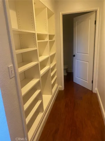 a view of walk in closet with empty racks