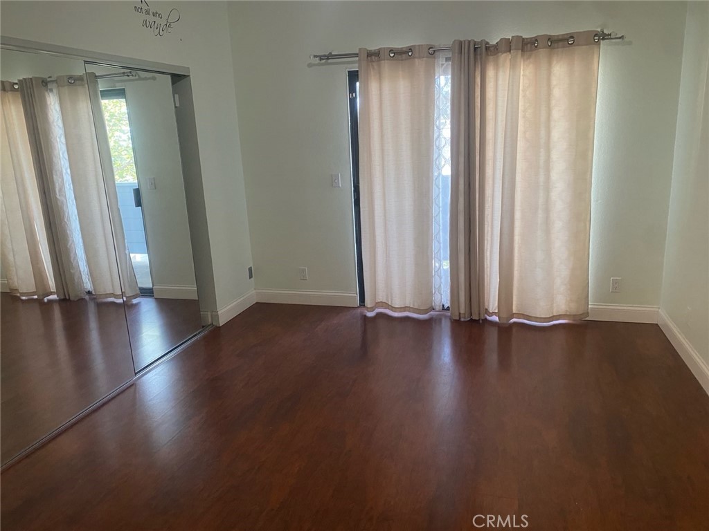 454 Walker Road San Dimas, CA 91773 - Photo 6 of 14 an empty room with wooden floor and windows
