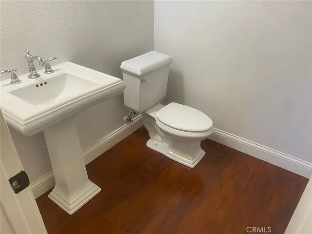 a white toilet sitting next to a bathroom sink
