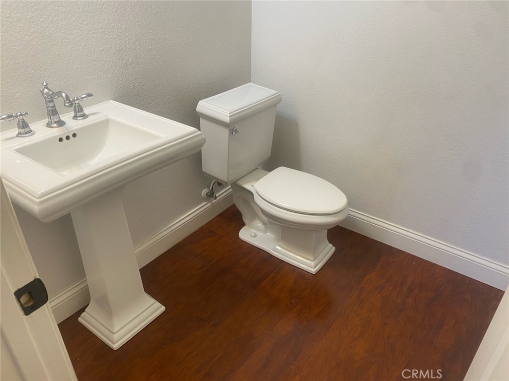 454 Walker Road San Dimas, CA 91773 - Photo 8 of 14 a white toilet sitting next to a bathroom sink