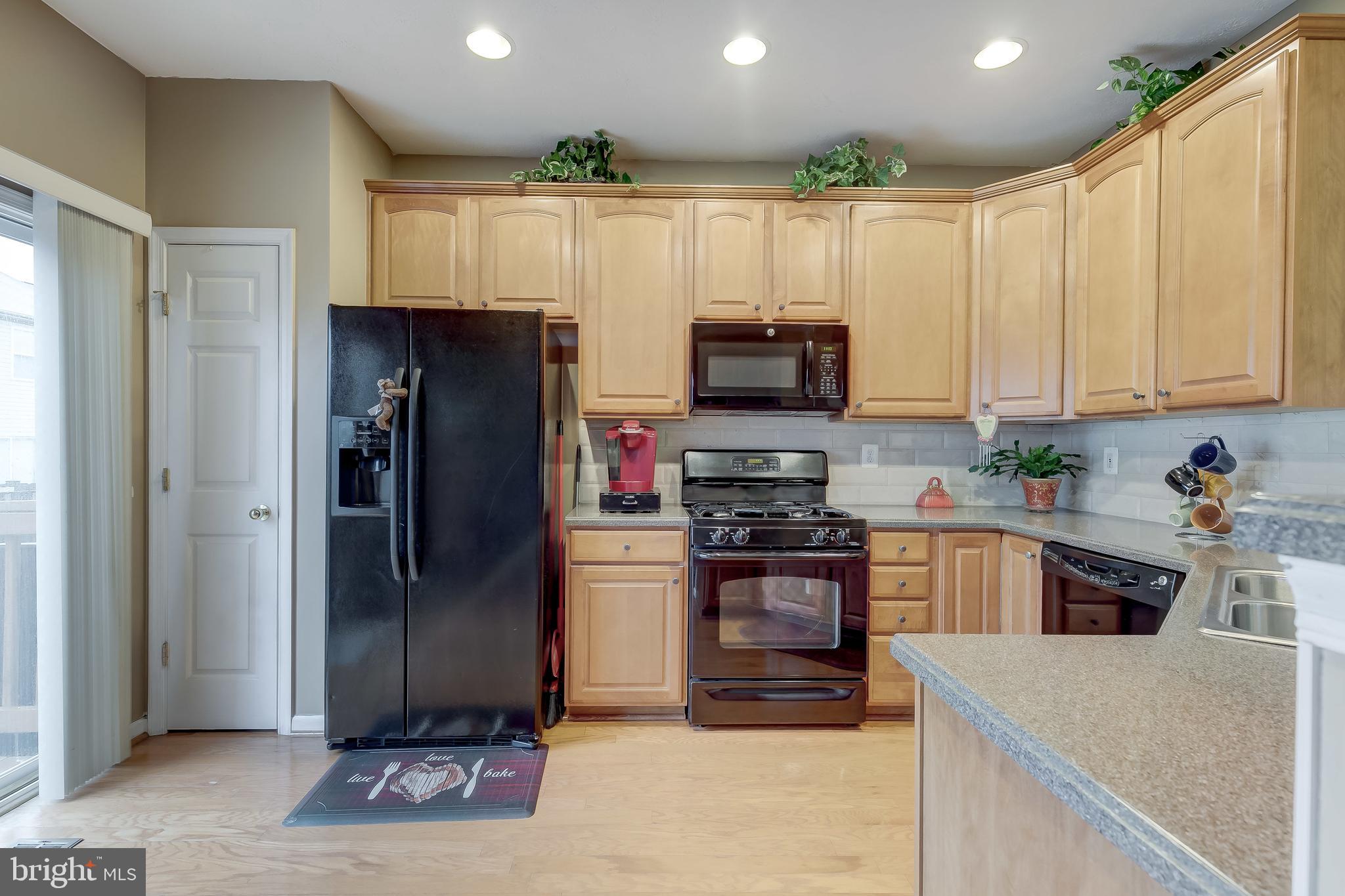 9727 Biggs Road Baltimore, MD 21220 - Photo 15 of 35 a kitchen with stainless steel appliances granite countertop a refrigerator and a stove top oven