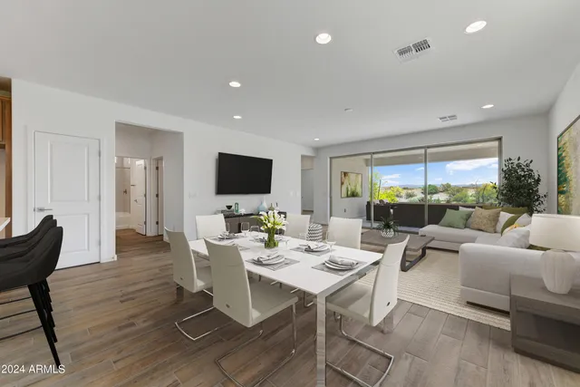 a living room with furniture a flat screen tv and a large window