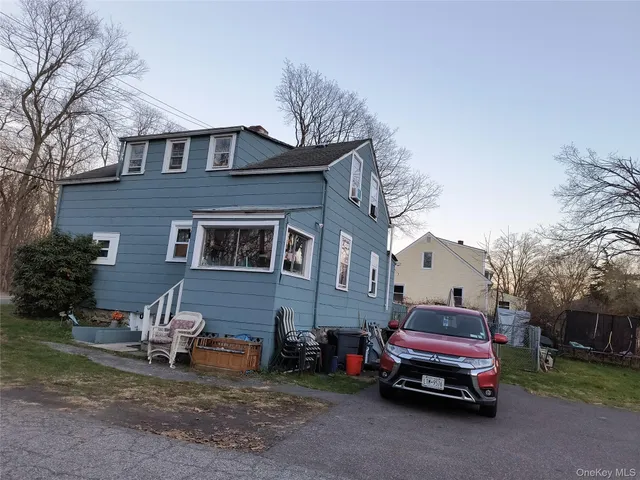 a car parked in front of a brick house