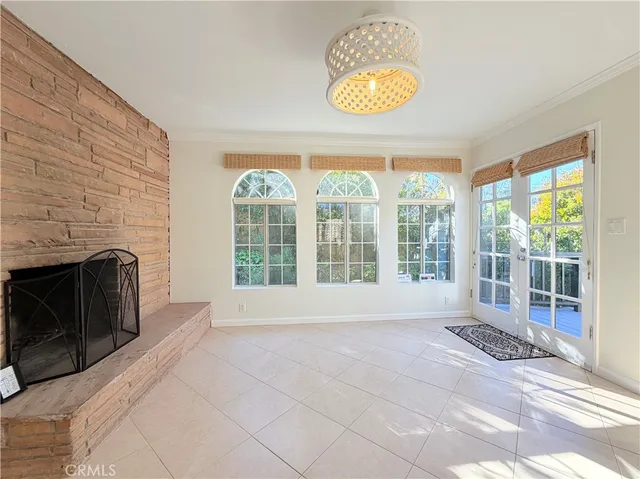 a view of an empty room with a fireplace and a large window