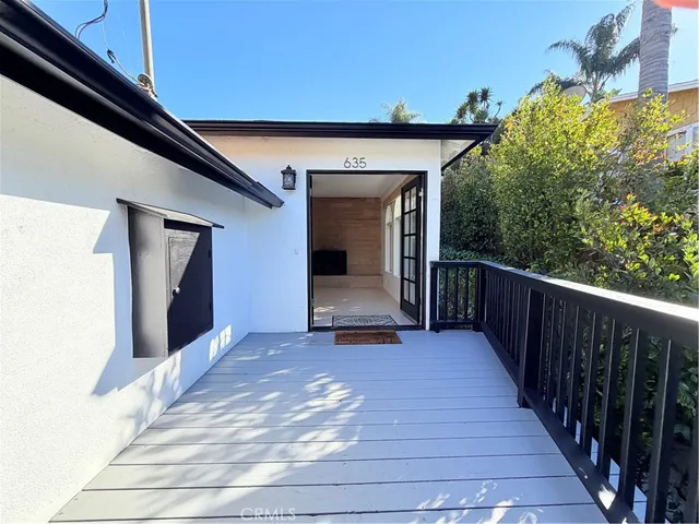 a view of a door and wooden floor