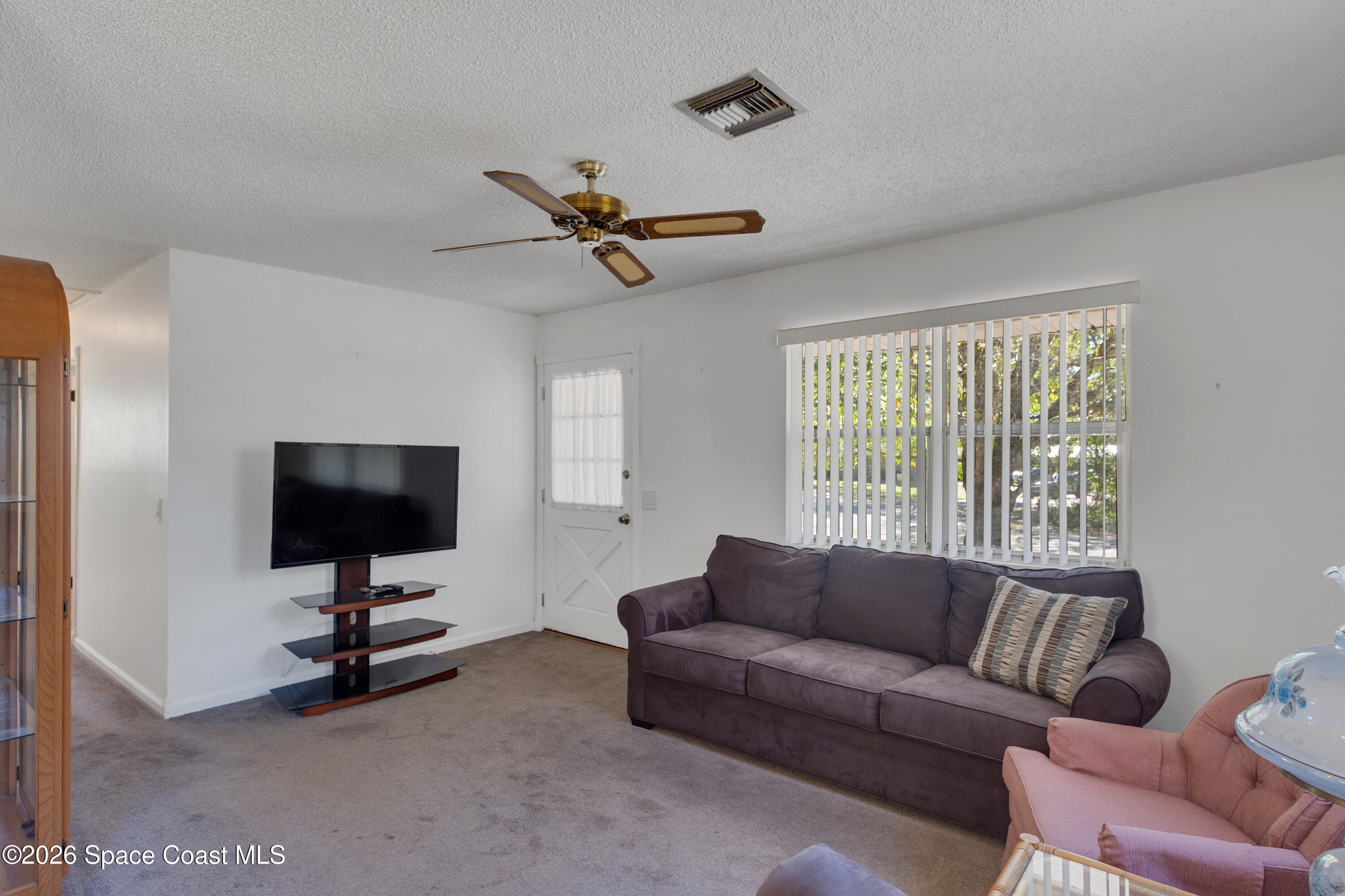 117 Acorn Terrace Sebastian, FL 32958 - Photo 20 of 33 a living room with furniture and a flat screen tv