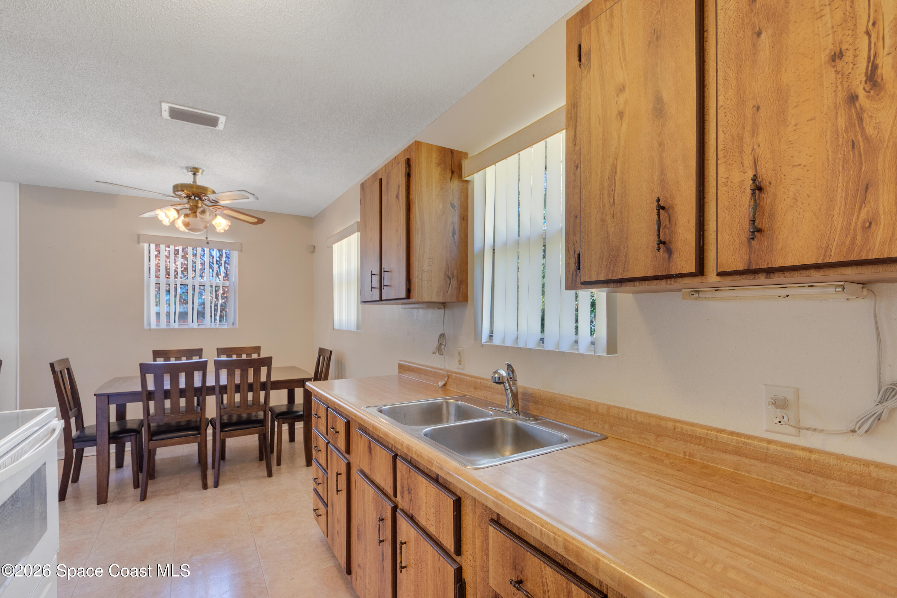 117 Acorn Terrace Sebastian, FL 32958 - Photo 24 of 33 a kitchen with a sink and cabinets