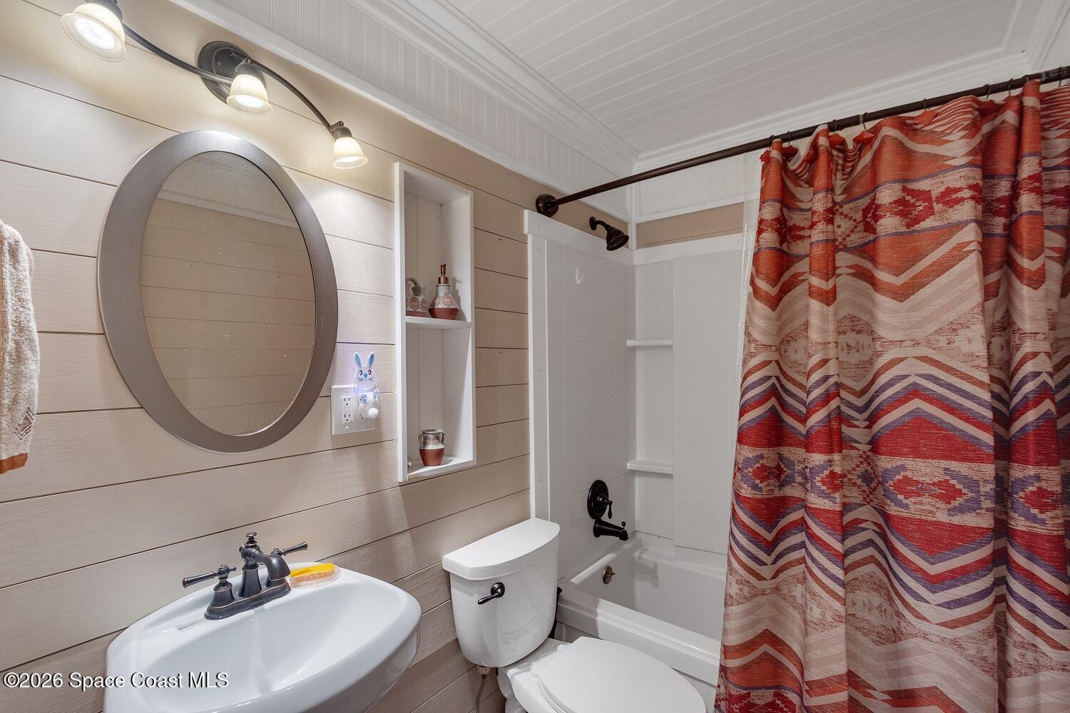 117 Acorn Terrace Sebastian, FL 32958 - Photo 32 of 33 a bathroom with a toilet sink and mirror