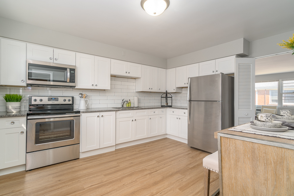 38 South Kensington Avenue, Unit 6 La Grange, IL 60525 - Photo 4 of 23 a kitchen with a refrigerator stove and white cabinets