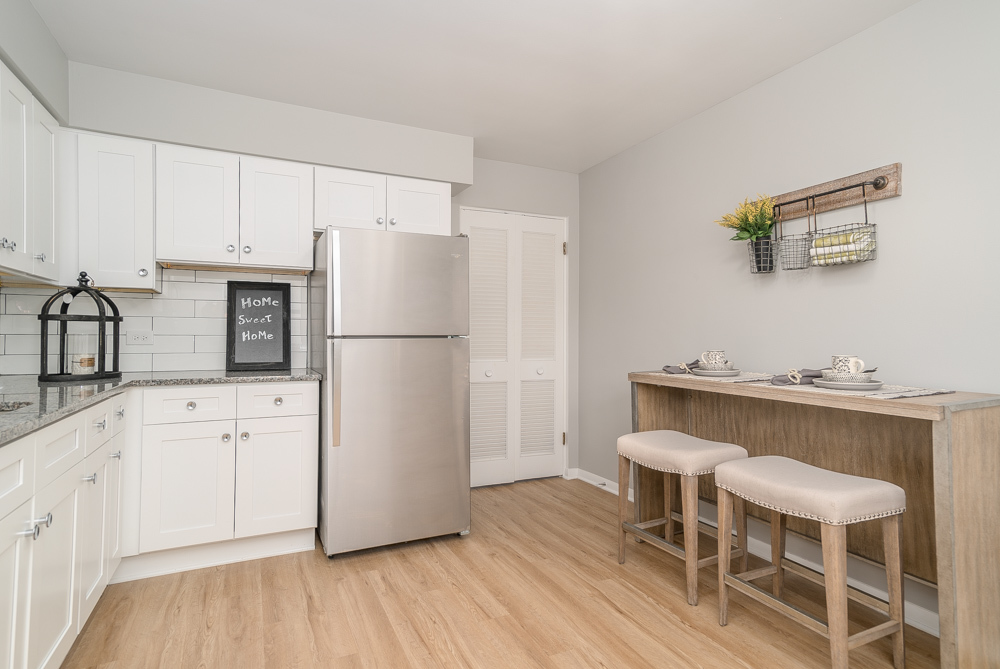 38 South Kensington Avenue, Unit 6 La Grange, IL 60525 - Photo 8 of 23 a kitchen with a refrigerator a table and chairs