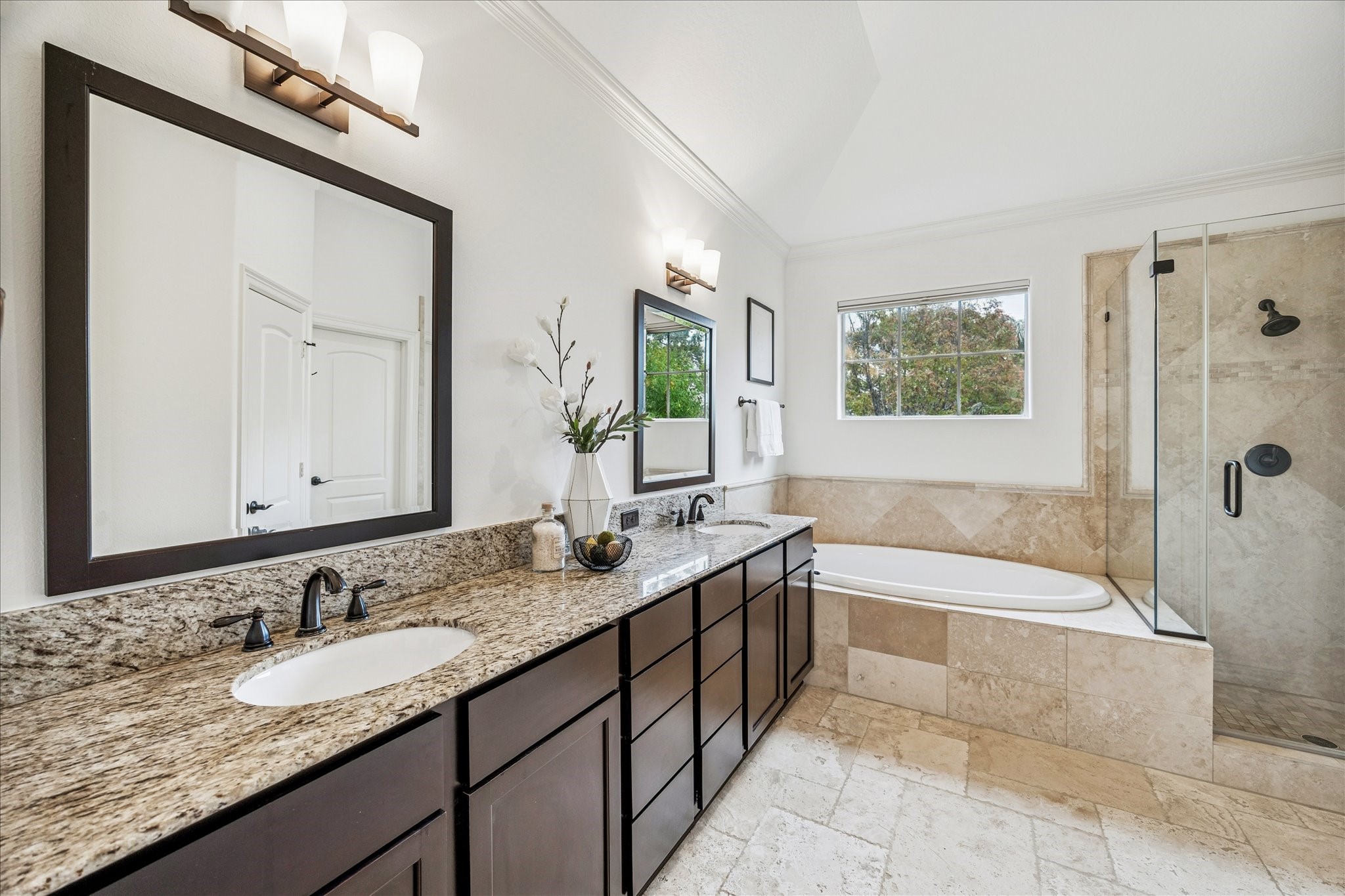 4418 Rose Street Houston, TX 77007 - Photo 21 of 34 a bathroom with a granite countertop bathtub a double vanity sink and a large mirror
