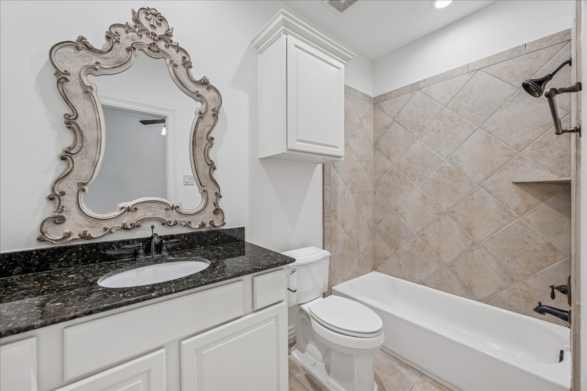 4418 Rose Street Houston, TX 77007 - Photo 27 of 34 a bathroom with a granite countertop sink a toilet and bathtub