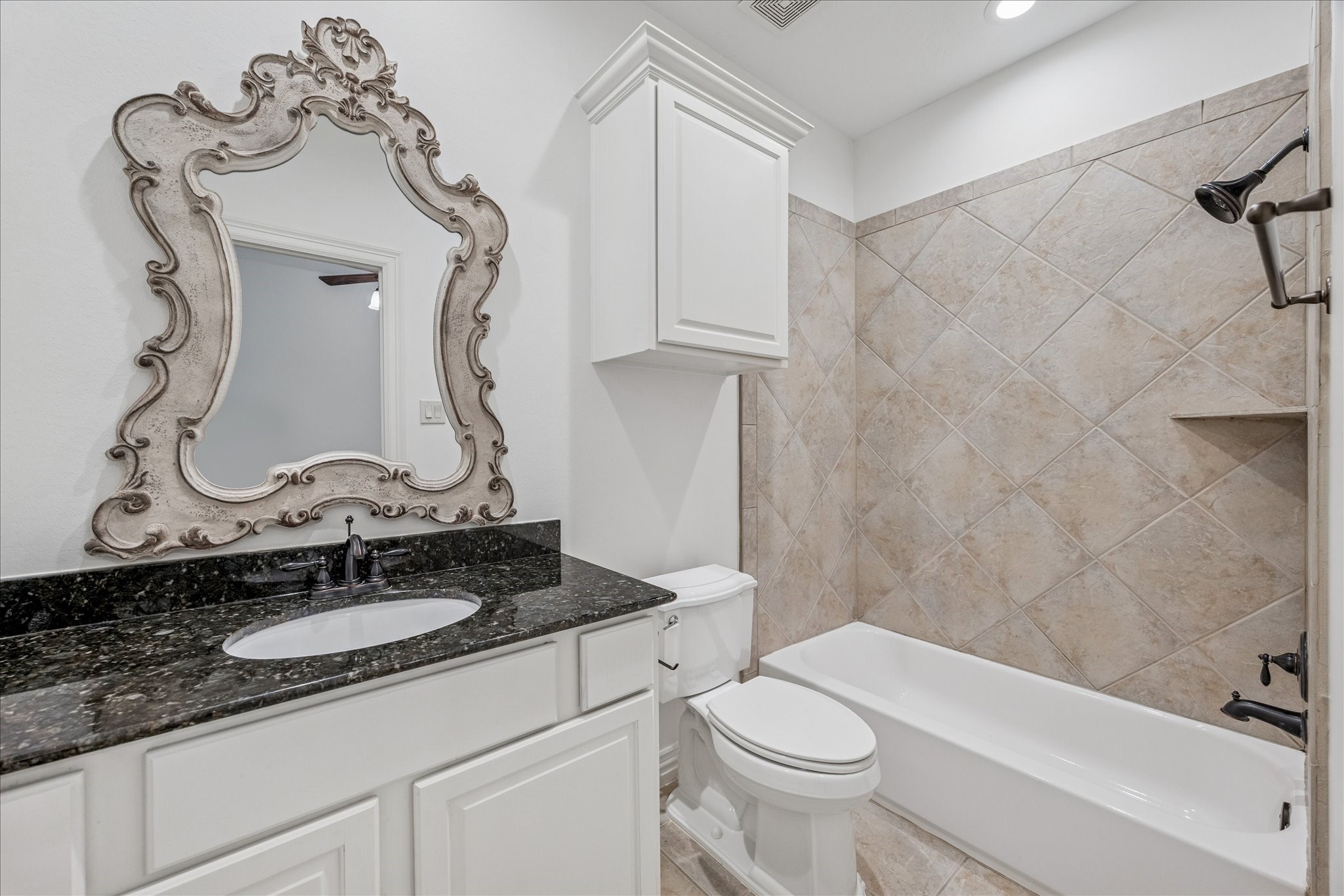 4418 Rose Street Houston, TX 77007 - Photo 27 of 34 a bathroom with a granite countertop sink a toilet and bathtub