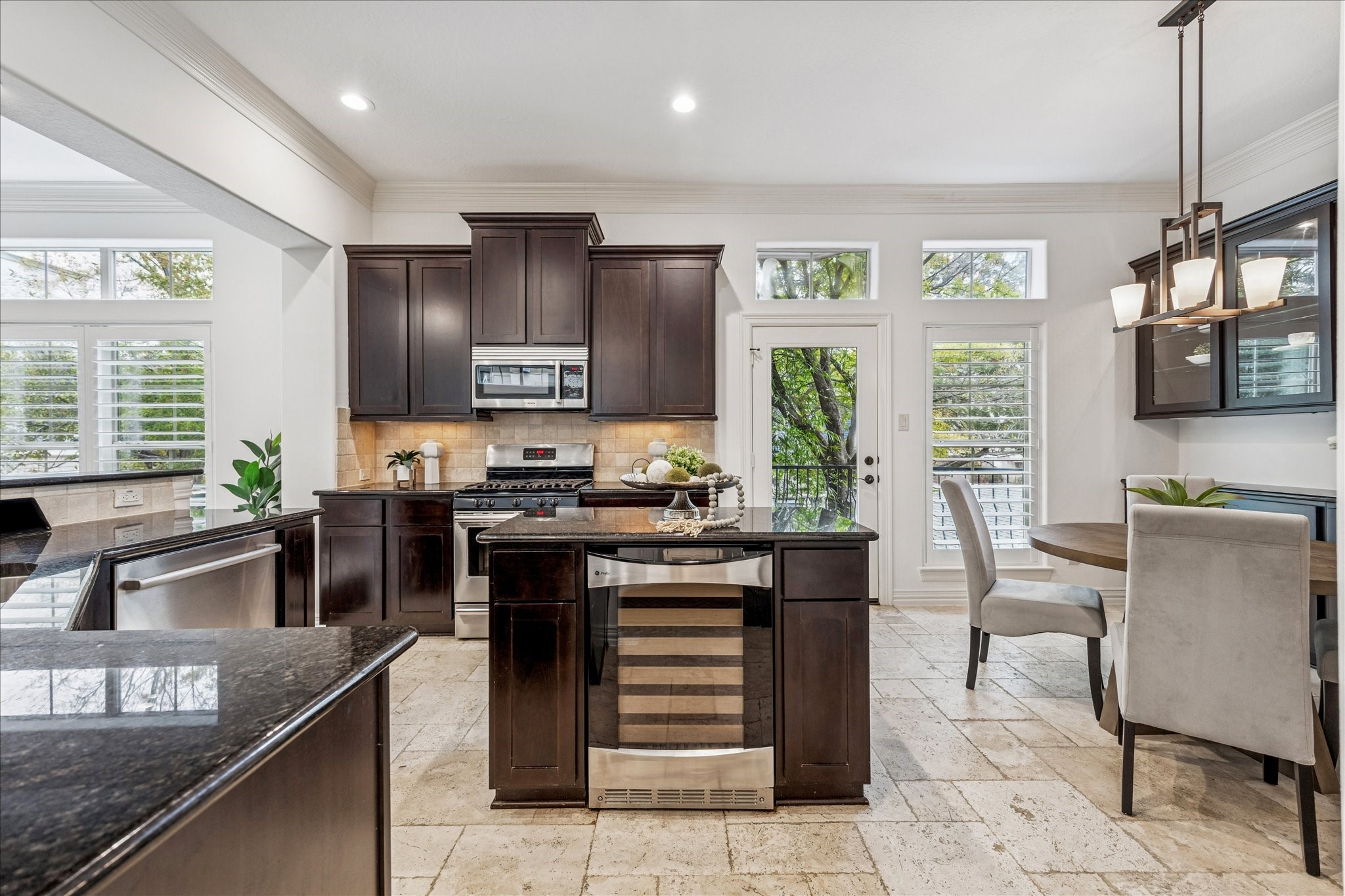 4418 Rose Street Houston, TX 77007 - Photo 4 of 34 a kitchen with stainless steel appliances granite countertop a stove top oven a sink dishwasher a dining table and chairs with wooden floor