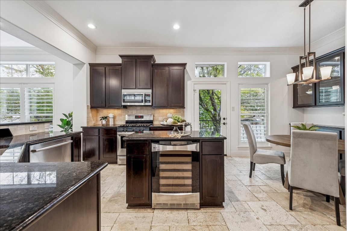 4418 Rose Street Houston, TX 77007 - Photo 4 of 34 Kitchen featuring dark cabinetry, granite countertops, a wine fridge built into the island, and generous prep space for daily use. Kitchen located on the second level.