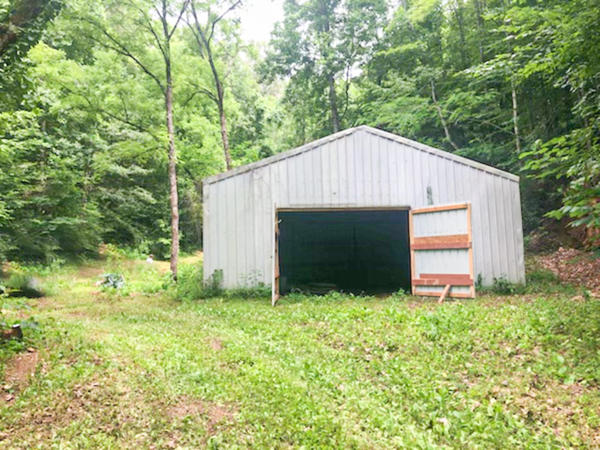 0 Sharp Road Sevierville, TN 37876 - Photo 3 of 27 a backyard of a house with large trees and plants