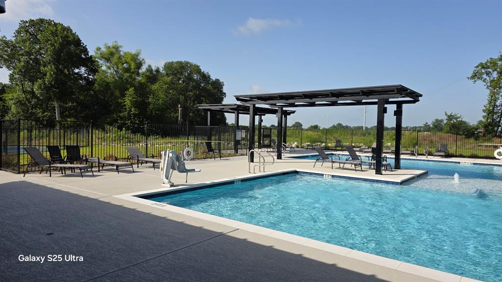 1614 Potomac Lane Blue Ridge, TX 75424 - Photo 11 of 18 Resort-style pool area featuring multiple swimming pools, concrete decking, and two pergolas providing shaded seating
